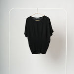 Bluză neagră vaporoasă cu mânecă scurtă tip fluture, vedere frontală, talie plisată și croială lejeră.