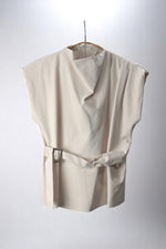 Bluză top bej cu croială modernă, turtleneck subtil și centură laterală cu cataramă pătrată.