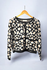 Cardigan cu imprimeu animalier în nuanțe de bej și alb pe fundal negru, vedere frontală, închis cu nasturi aurii decorativi.