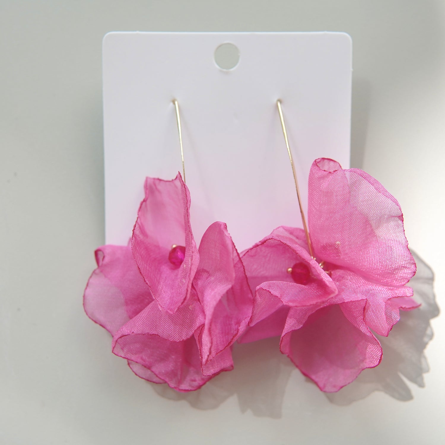 Cercei statement din oțel inoxidabil, cu flori satinate fucsia și accente delicate.