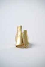 Inel masiv ajustabil, din metal auriu, cu suprafețe curbe și muchii geometrice.