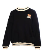 Poncho hanorac negru, decorat cu aplicație urs și detalii din tricot la guler și manșete.