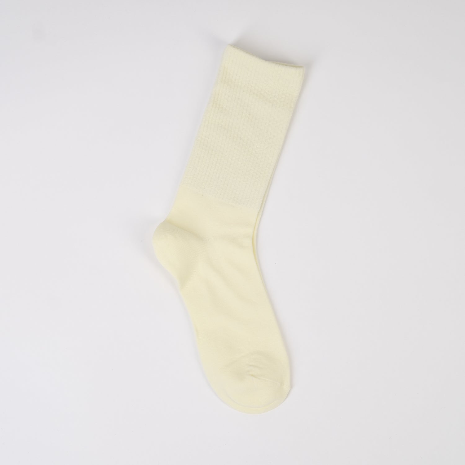 Șosetă lungă în nuanță crem deschis, tricotată fin din bumbac cu elastic în partea de sus