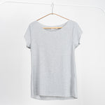 Tricou basic gri deschis cu mânecă scurtă și croială lejeră, fotografiat pe umeraș alb.