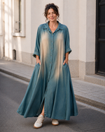 Rochie lungă tip cămașă din denim fluid albastru vintigizat, cu nasturi și croială oversize, vedere frontală — All Above Boutique.