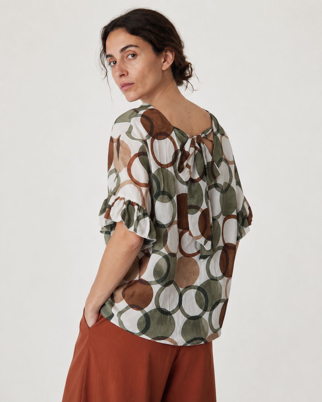 Detaliu imprimeu cu cercuri colorate pe bluza cu decolteu V. All Above Boutique.
