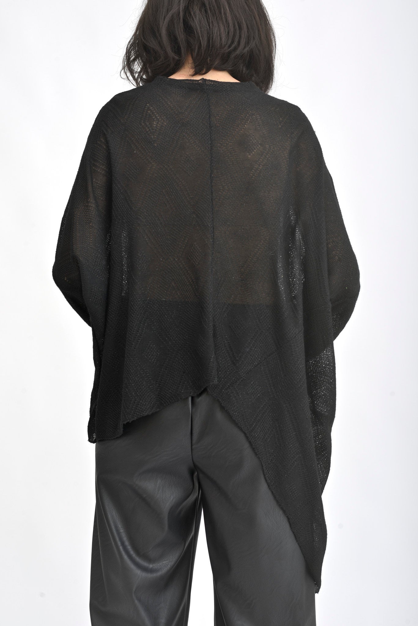 Vedere din spate a unei bluze asimetrice cu sclipici, croială amplă și lungime variabilă