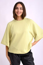 All Above Boutique pastel yellow relaxed fit three-quarter sleeve top made of polyester, viscose, and elastane blend.