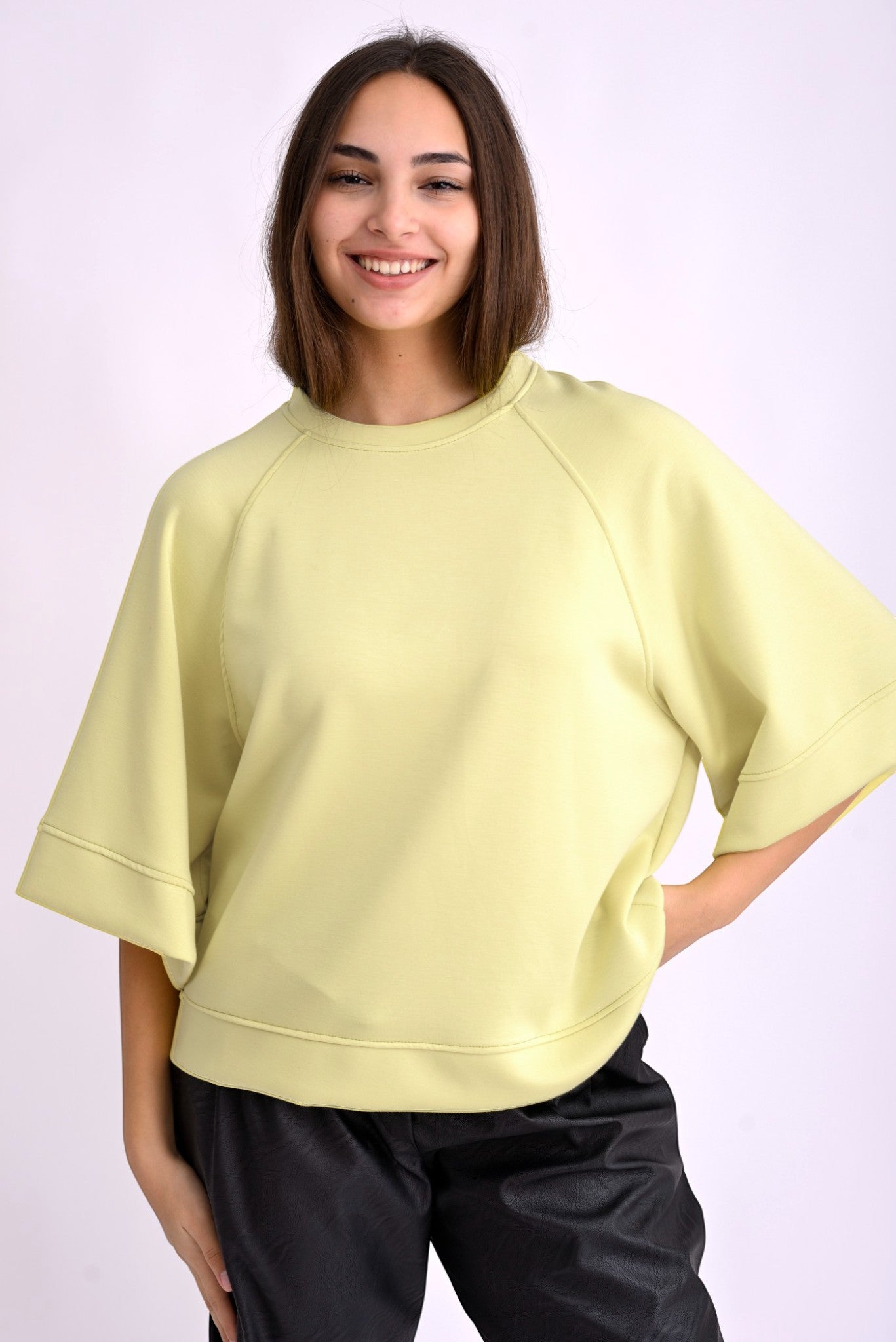 All Above Boutique pastel yellow relaxed fit three-quarter sleeve top made of polyester, viscose, and elastane blend.