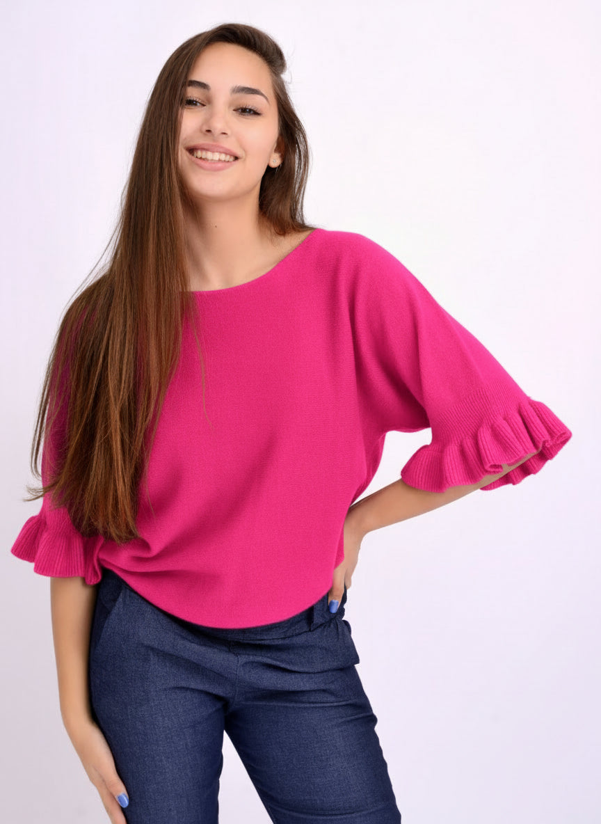 Bluză din tricot soft cu mânecă 3/4 și volan la terminație, croială lejeră și umeri căzuți.