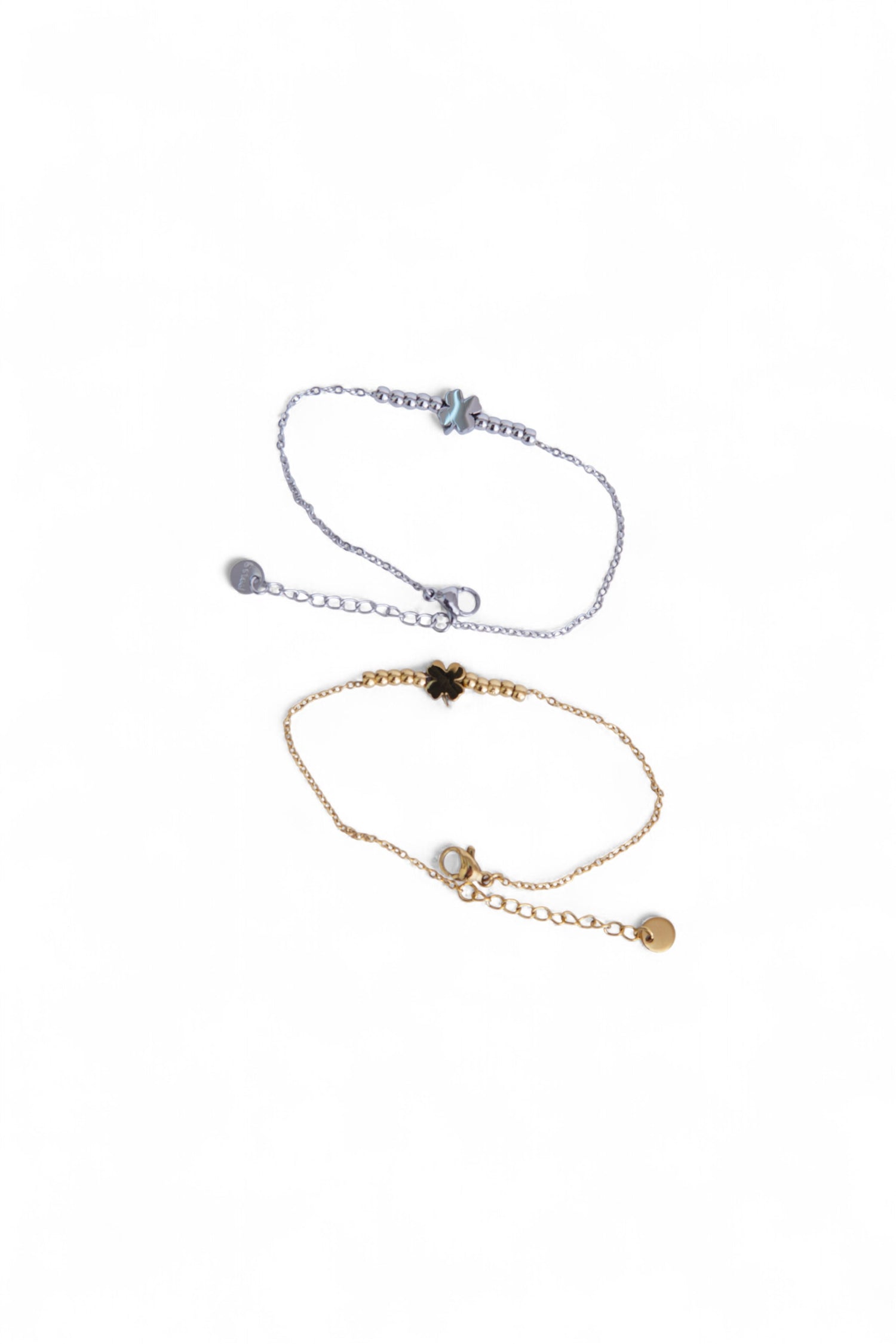 Două brățări cu trifoi, una aurie și una argintie, realizate din oțel inoxidabil, prezentate împreună.