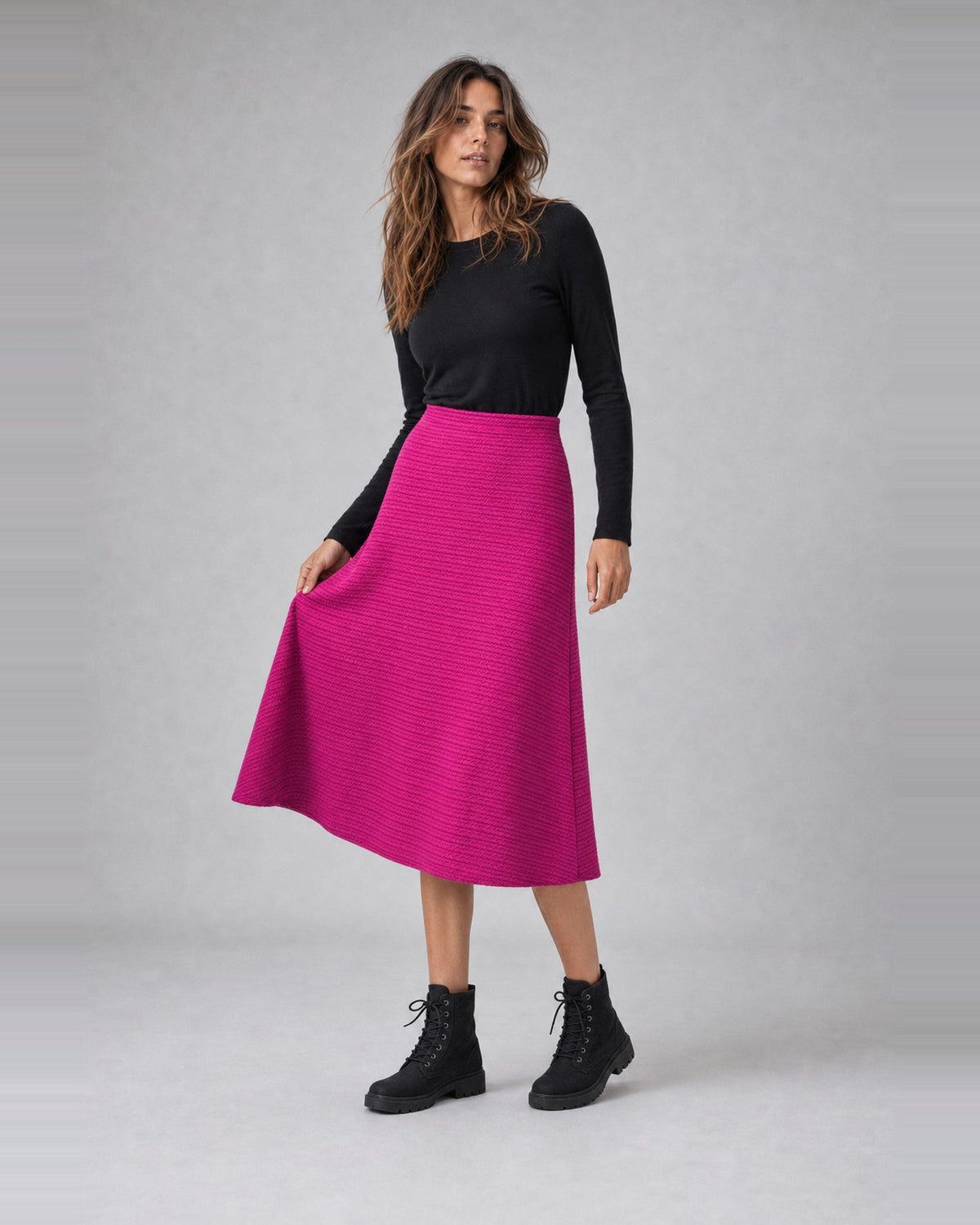 Fustă evazată din jerse cu relief zig-zag, în nuanța fucsia, purtată pe model, All Above Boutique
