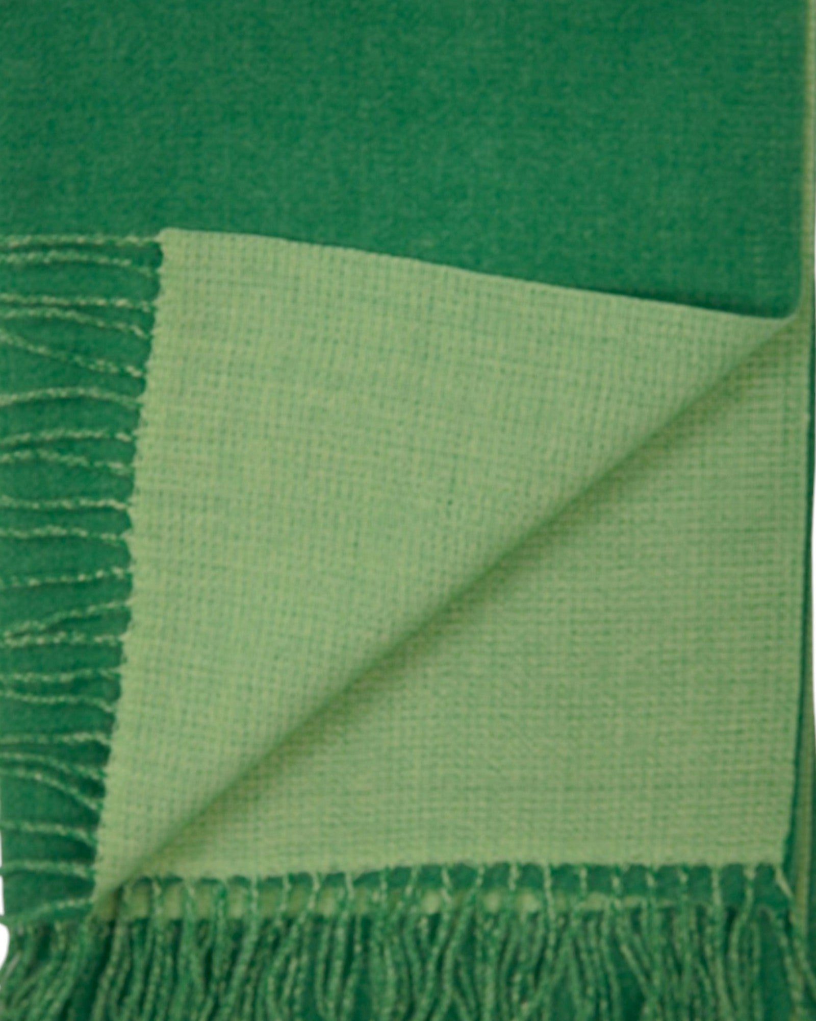 Detaliu de material al fularului pashmina verde, cu țesătură moale și margini finisate.