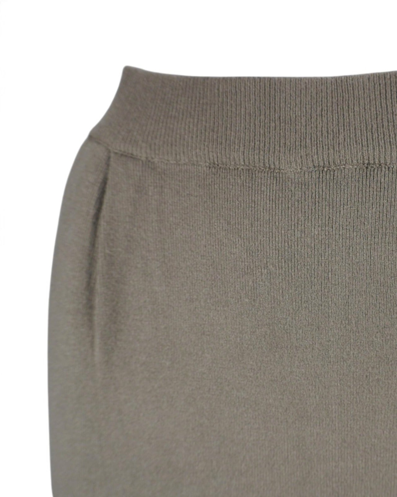 Detaliu lateral al unei fuste lungi din tricot moale, cu buzunare practice.