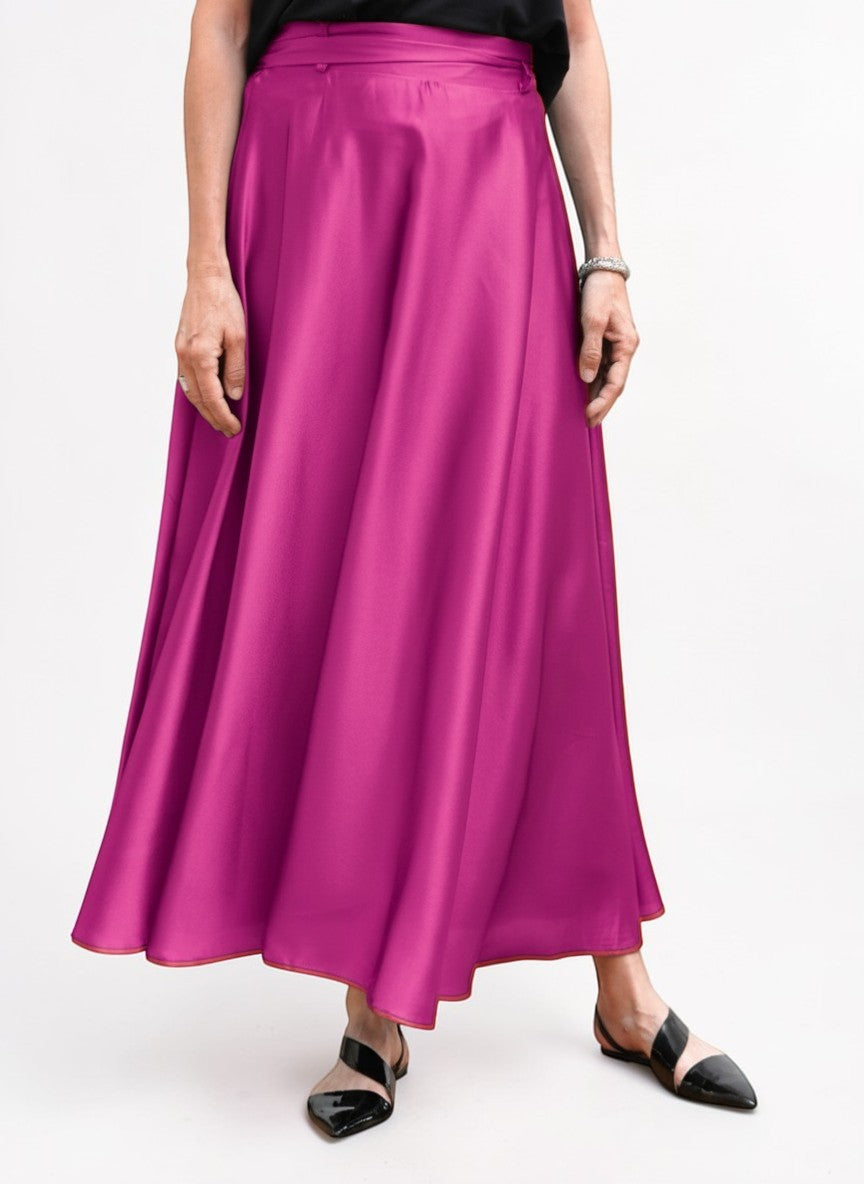 Fustă maxi satinată roz, fotografiată din unghi lateral, evidențiind fluiditatea materialului.