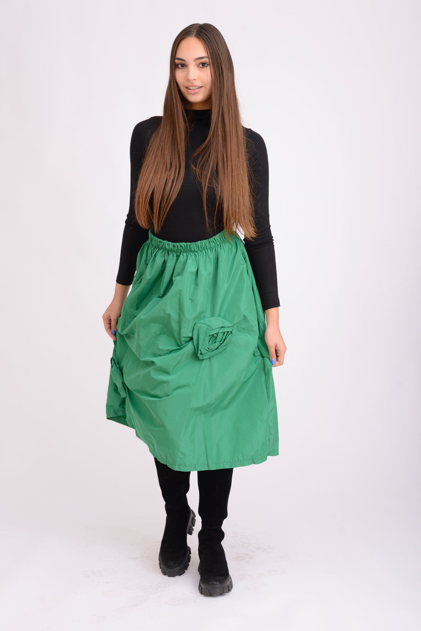 Detaliu al materialului tip tafta verde și al florilor aplicate, cu textură elegantă și luciu subtil.