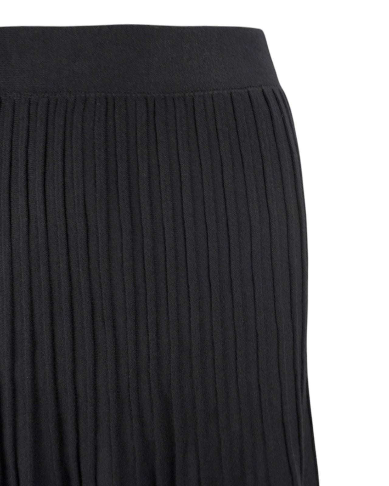 Detaliu al materialului plisat din tricot negru combinat cu strat transparent din tul, elegant și modern.