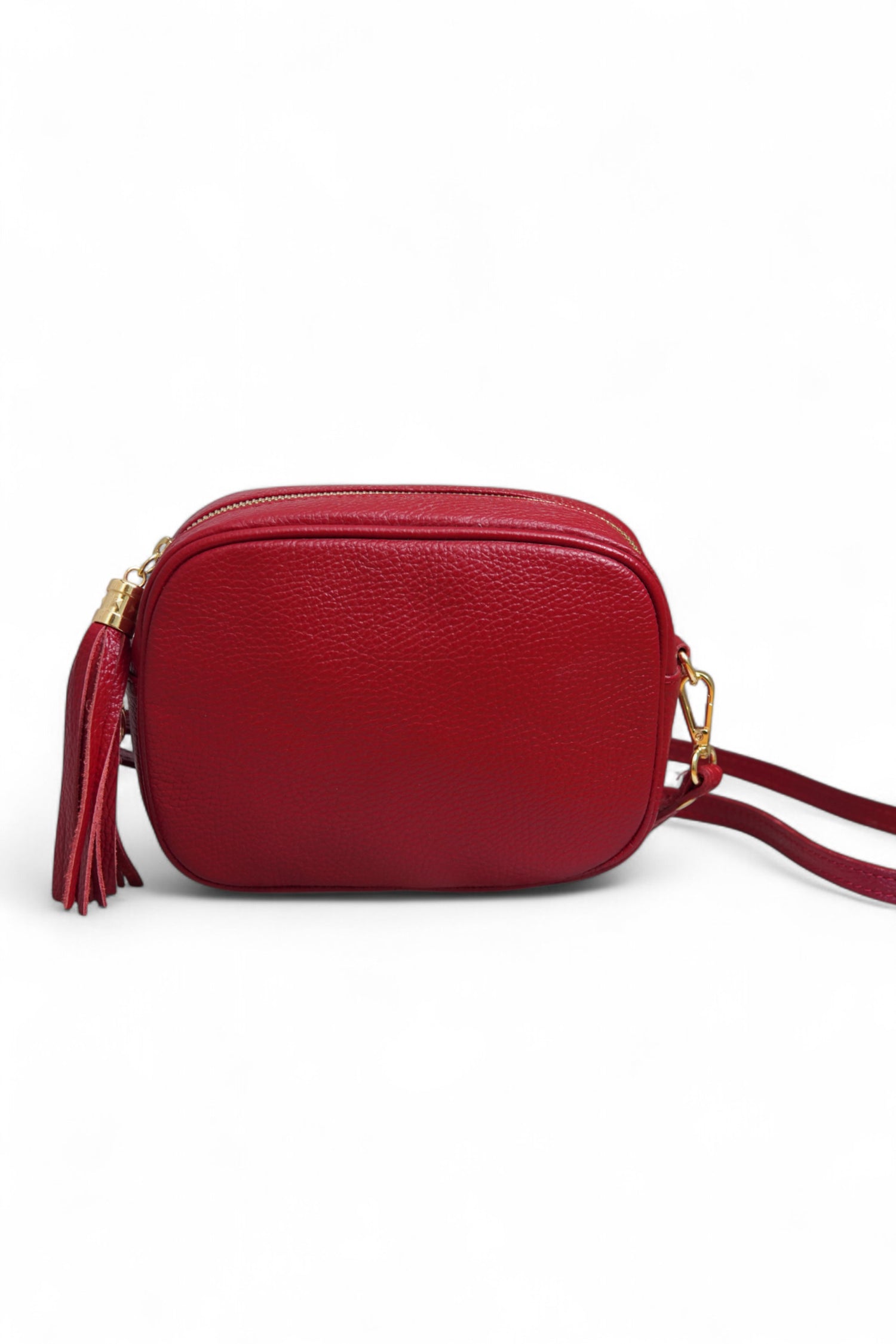 Geantă crossbody roșie din piele ecologică, cu detaliu de ciucure și curea reglabilă.