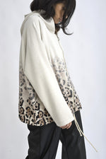 Vedere laterală hanorac bej cu fermoar și glugă, cu mâneci lungi și finisaj lejer.