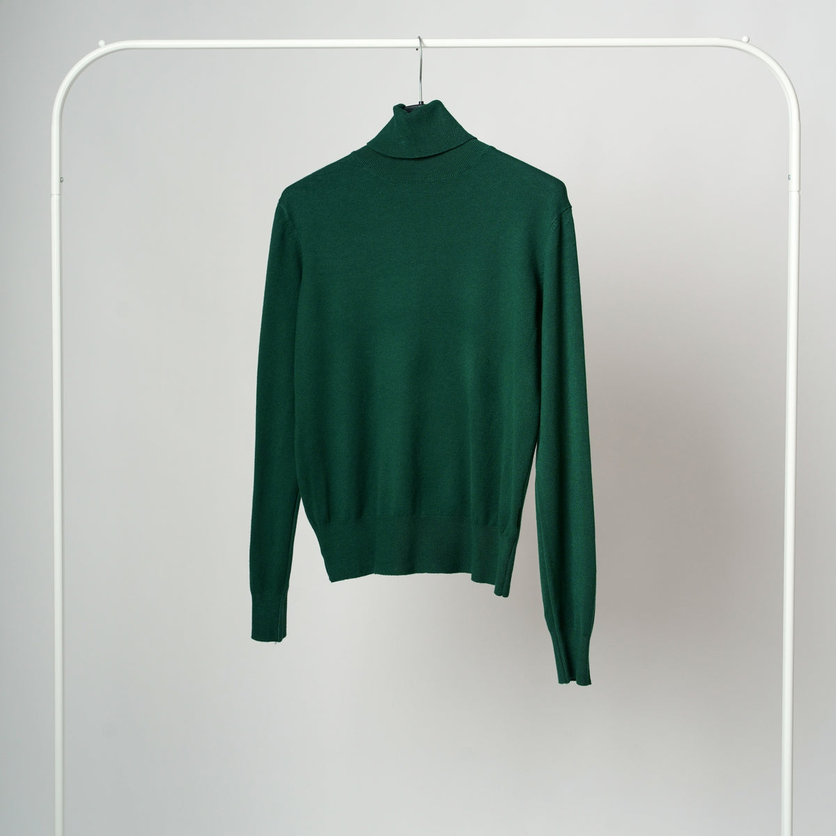 Maletă din tricot cu guler înalt și croi cambrat, în nuanța verde închis, vedere frontală.