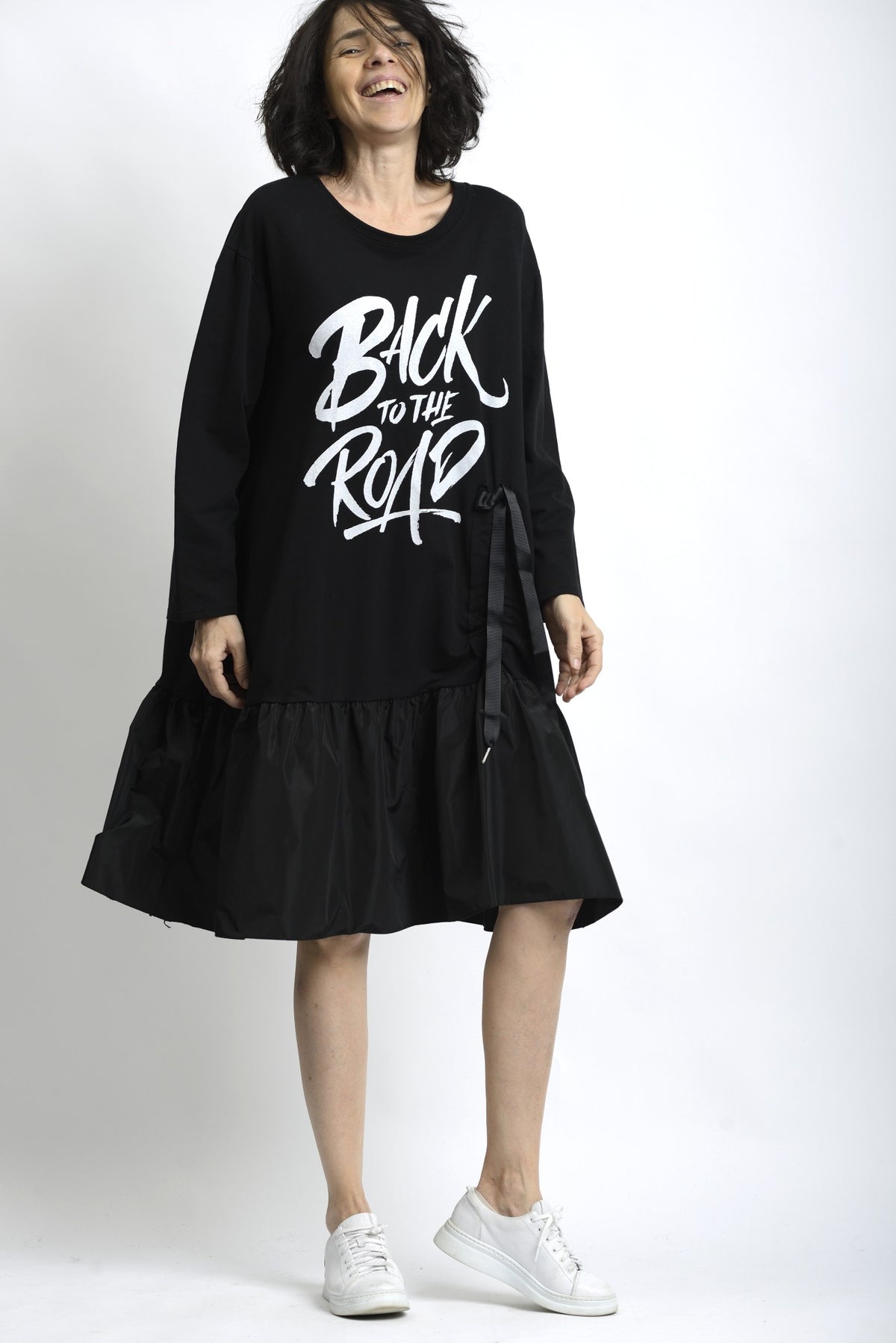 Vedere laterală a rochiei din jerse cu mâneci lungi și cădere fluidă.