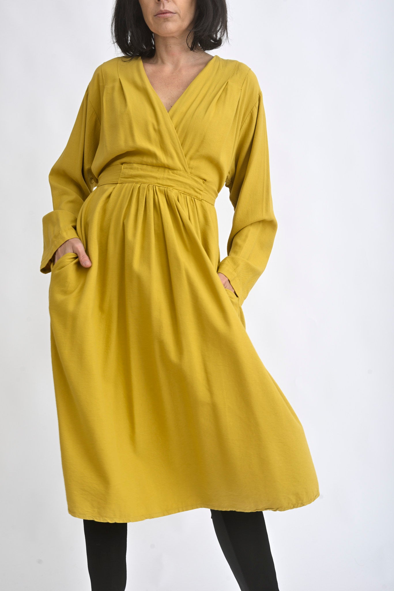 Rochie midi galben muștar cu decolteu petrecut și mâneci lungi, fotografiată pe umeraș, pe fundal alb.