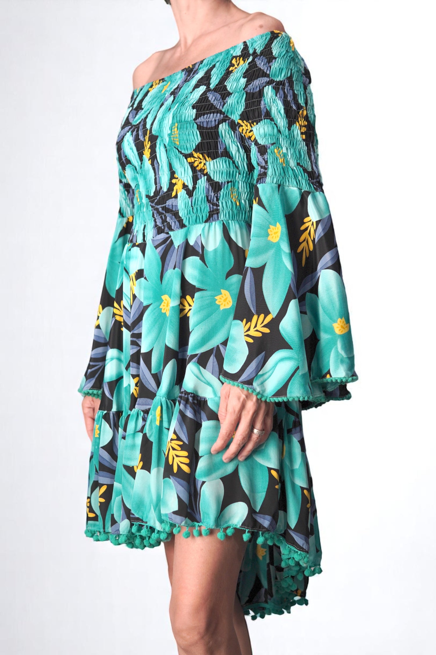 Detaliu bust rochie scurtă cu umeri goi și imprimeu floral turcoaz