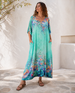 Rochie lungă albastră mătăsoasă cu mânecă scurtă și decolteu în V, vedere frontală. All Above Boutique.
