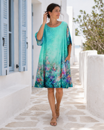 Rochie bleu mătăsoasă cu mânecă scurtă și imprimeuri, vedere frontală. All Above Boutique.