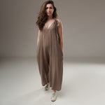 Salopetă culotte din in bej‑taupe, lejeră, cu bretele ajustabile și buzunare ascunse pe cusătură, prezentare frontală pe model.