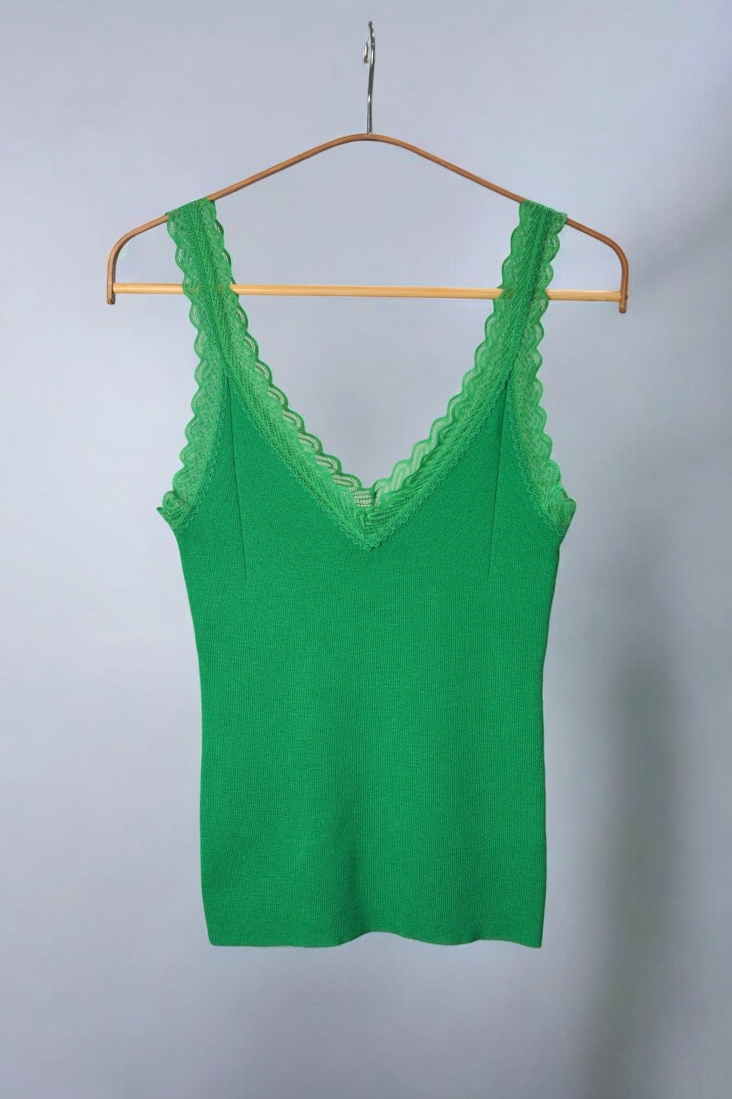 Top verde cu bretele late din dantelă, design feminin și delicat.