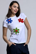 Tricou alb cu flori brodate integrat într-o ținută casual