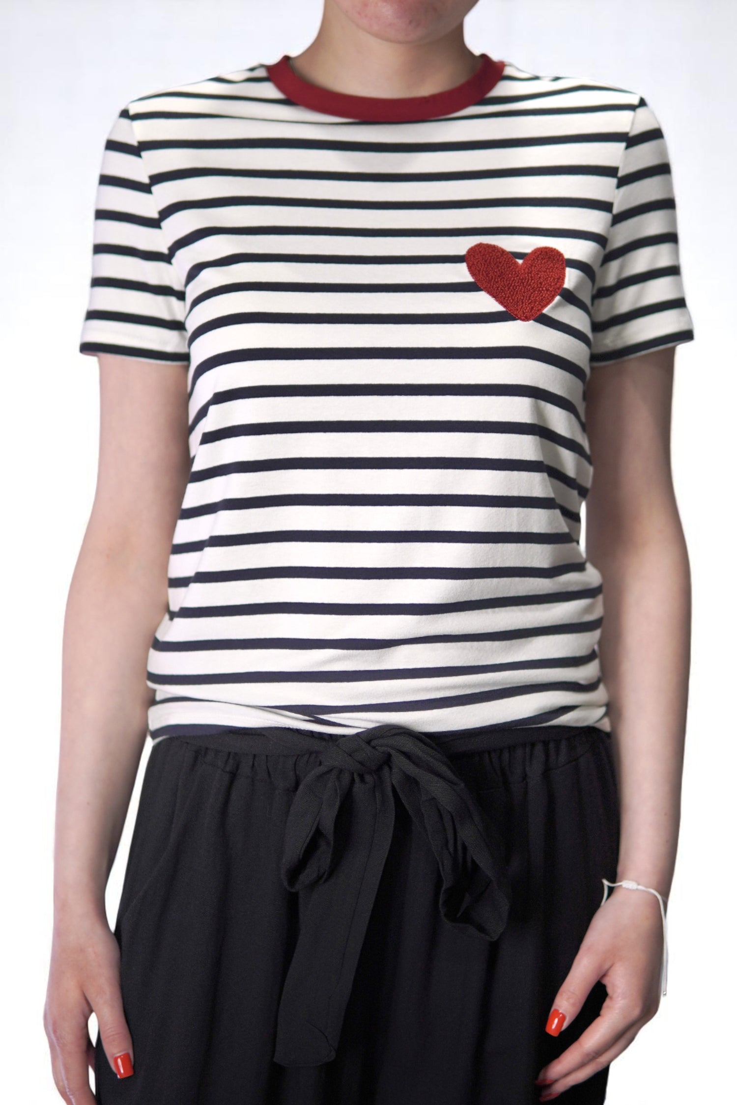 Tricou cu dungi și inimă roșie purtat cu nod decorativ în talie.