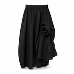 All Above Boutique black cotton asymmetric skirt with applied 3D floral detail and elastic waist.