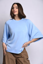 All Above Boutique light blue relaxed fit three-quarter sleeve top made of polyester, viscose, and elastane blend.