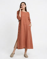 All Above Boutique terracotta Tencel midi dress with side buttons, slits, and pockets. Loose fit, 3/4 sleeves.