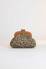 All Above Boutique animal print crossbody bag with wooden frame and gold chain. Features a leopard print fabric and a clasp closure.
