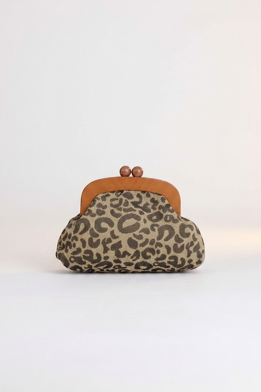 All Above Boutique animal print crossbody bag with wooden frame and gold chain. Features a leopard print fabric and a clasp closure.