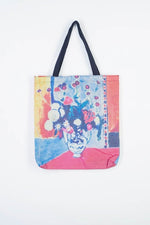 All Above Boutique artistic tote bag with floral print on canvas, featuring a vase of flowers. Durable and spacious for daily use.