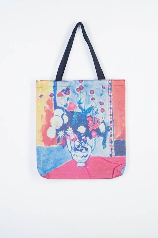 All Above Boutique artistic tote bag with floral print on canvas, featuring a vase of flowers. Durable and spacious for daily use.