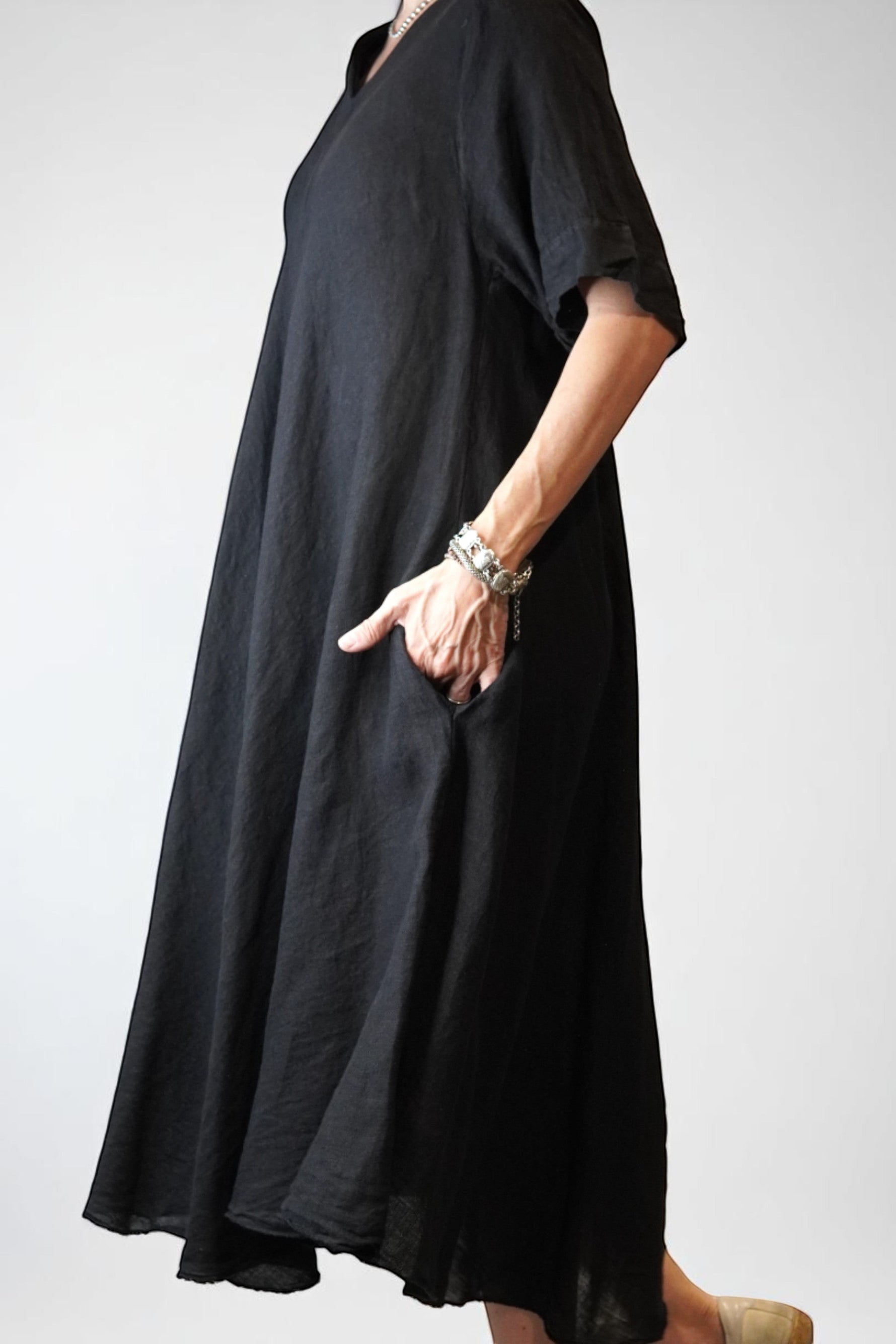 All Above Boutique black 100% linen V-neck midi dress with short sleeves and side pockets, relaxed fit.