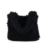 All Above Boutique black teddy bag with fluffy texture and double handles, perfect for casual wear.