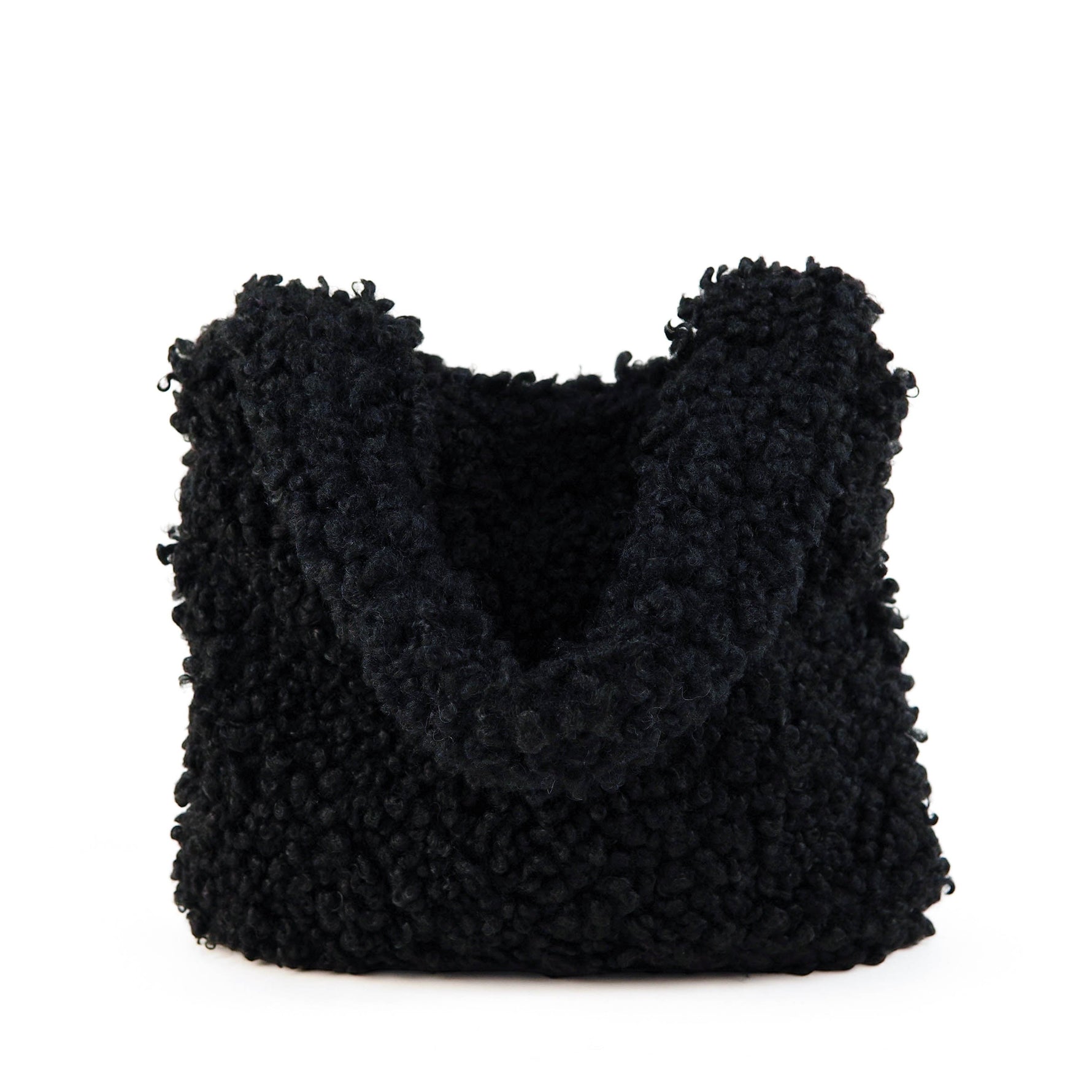 All Above Boutique black teddy bag with fluffy texture and double handles, perfect for casual wear.