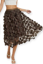All Above Boutique brown midi tulle skirt with applied petal details and elastic waist. Elegant, flowing design.