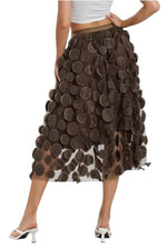All Above Boutique brown midi tulle skirt with applied petal-like circles, elastic waist, and flowing A-line silhouette.