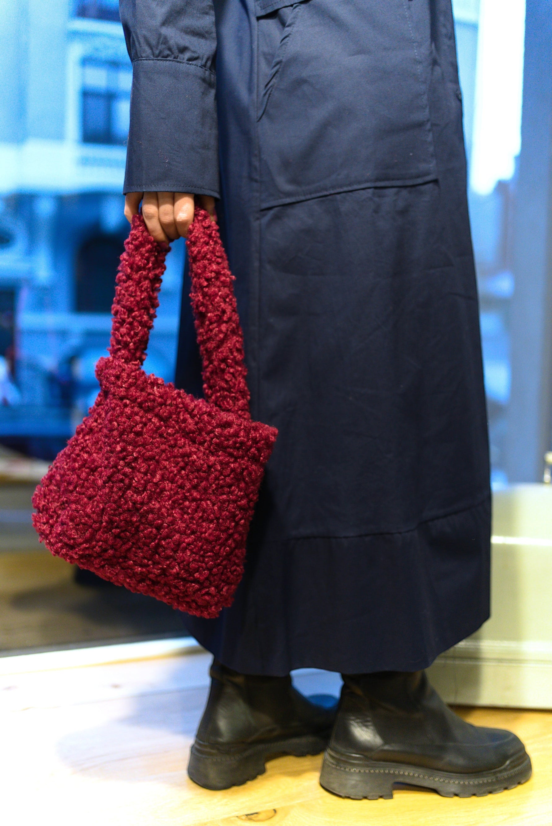 All Above Boutique burgundy teddy fabric handbag with double handles and magnetic snap closure. Modern chic style.