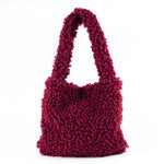 All Above Boutique burgundy teddy bag with double handles and magnetic snap closure. Soft, fluffy texture, ideal for casual wear.