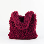 All Above Boutique burgundy teddy fabric tote bag with double handles and magnetic snap closure.
