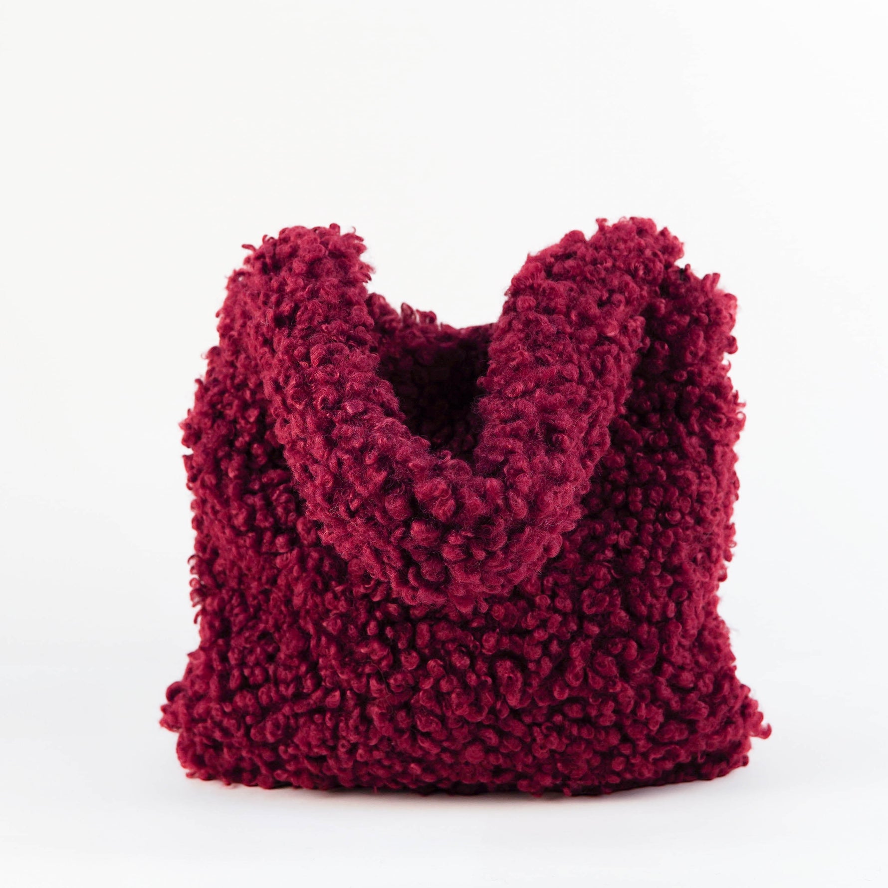 All Above Boutique burgundy teddy fabric tote bag with double handles and magnetic snap closure.