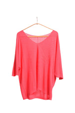 All Above Boutique coral pink V-neck relaxed fit knit sweater with dropped shoulders and a textured bob de orez finish.